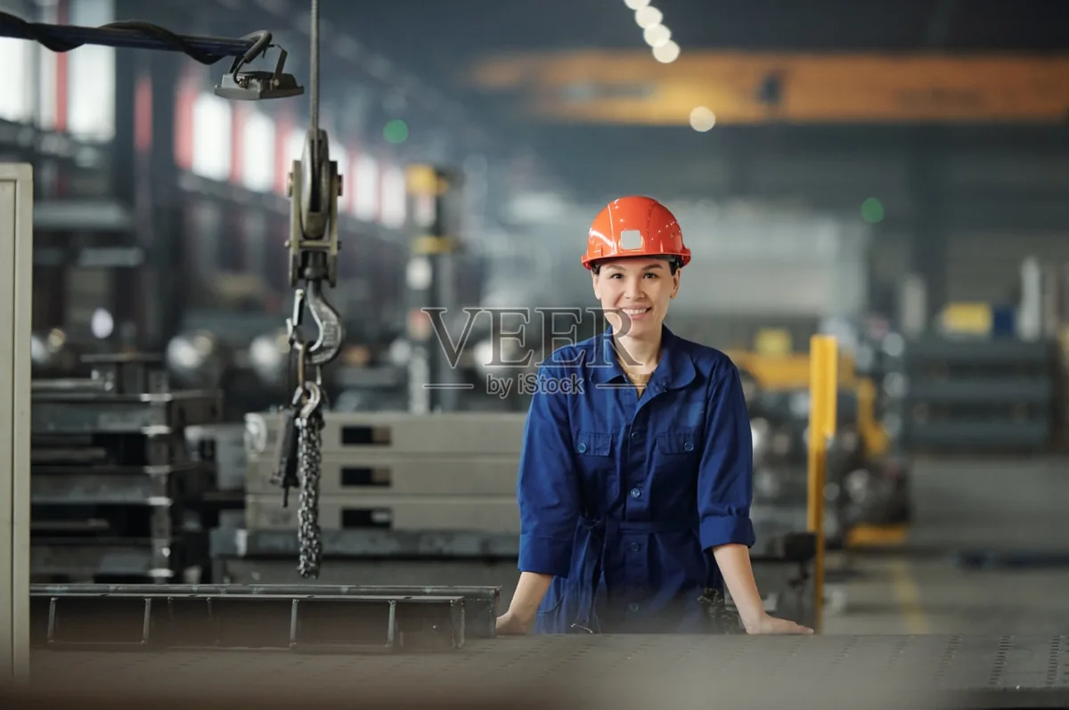 Worker near a workshop hoist for equipment maintenance lifting context