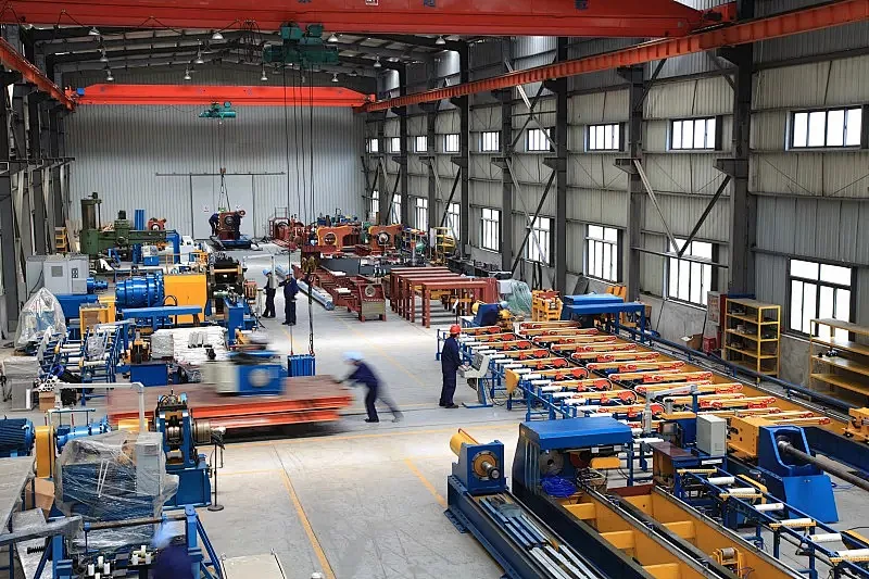 Workshop floor with overhead lifting equipment and production machinery